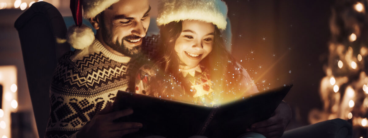 Father and daughter reading a magical holiday tale